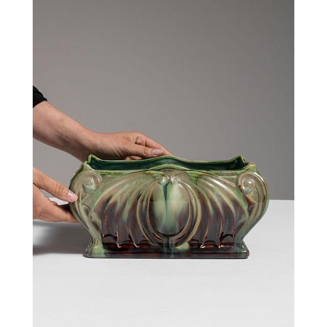 This 1910s Art Nouveau planter from Belgium is finished in green, worked in ceramic. Its design carries the Art Nouveau...