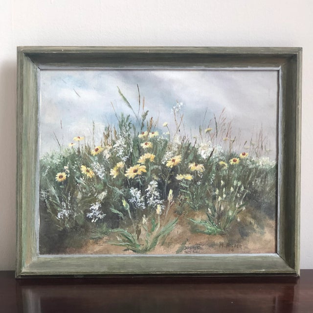 Offering a beautiful mid-century oil painting on canvas depicting a field of wildflowers under a cloudy summer sky. Small...