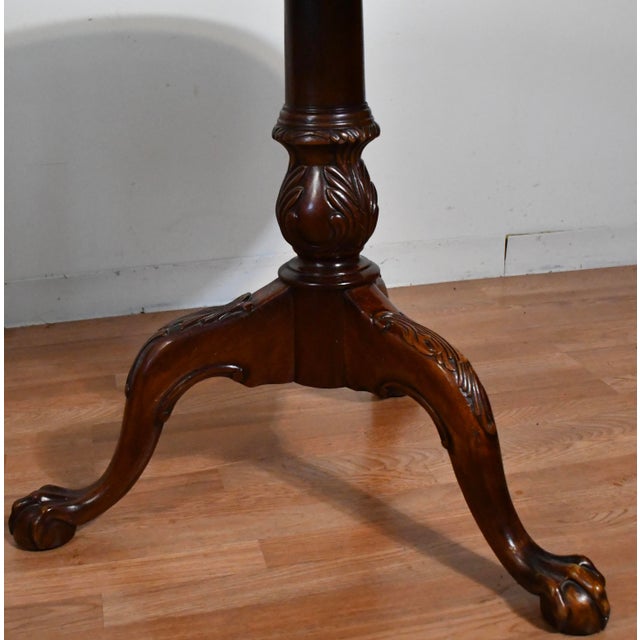 1940 English Chippendale round center table with smooth original polish circular top and reach mahogany wood .the table...