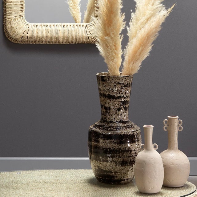 Vibrant patterns in a neutral palette that enhance, not overwhelm, elevate this ceramic vase. Water-safe, it can be...