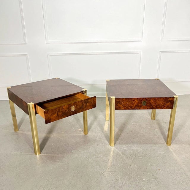 A pair of Regency style burl and brass side tables featuring beautiful rounded brass legs that inset neatly to the...