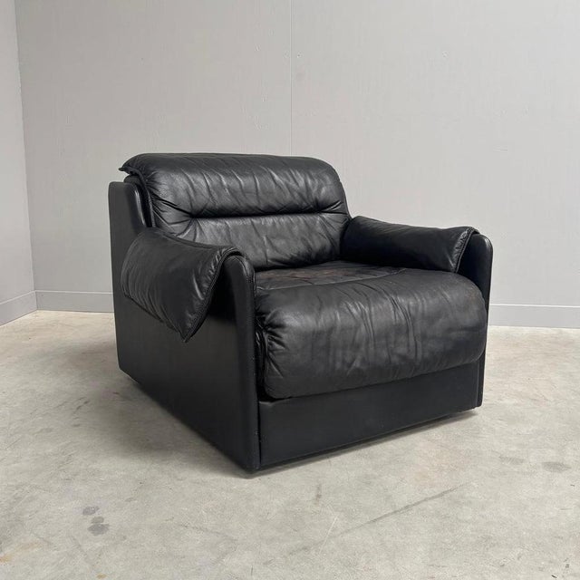 Remarks: Mid century lounge chair by Dreipunkt, Germany 1970s. Strong and heavy wooden frame with black leather...