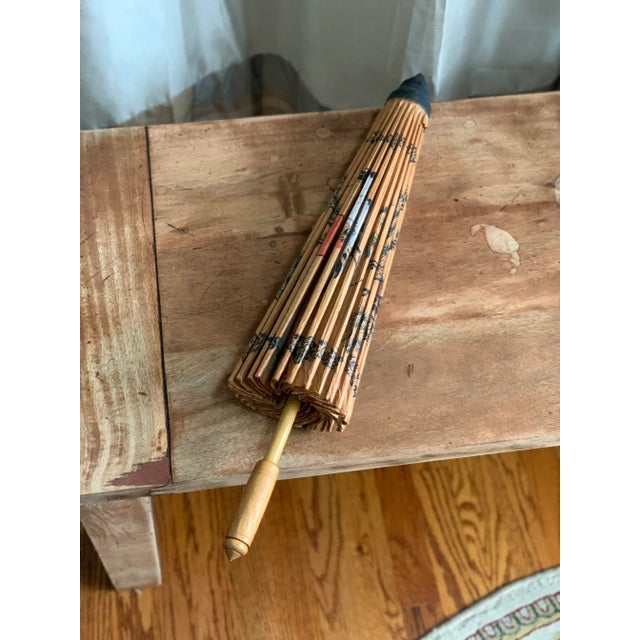 Japanese antique painted paper umbrella with bamboo holder. Some rips in the paper shown in photos. Works well for a...