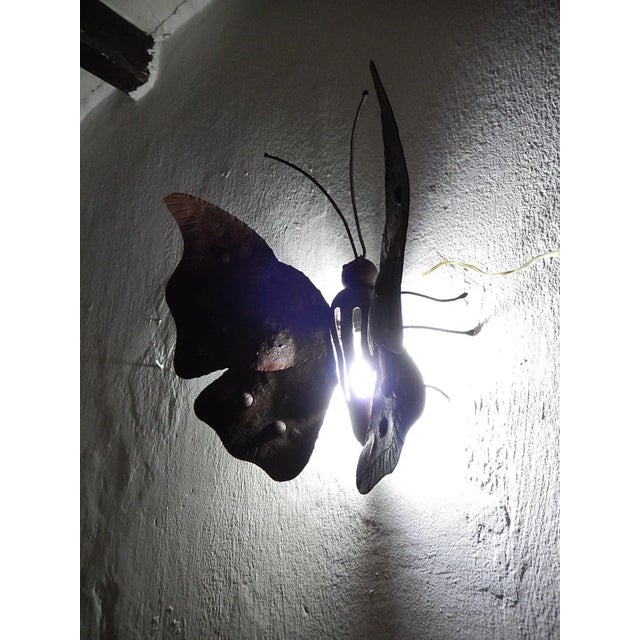 Housing one light. Will be rewired and ready to hang, with appropriate socket for country. Wrought iron body that has been...