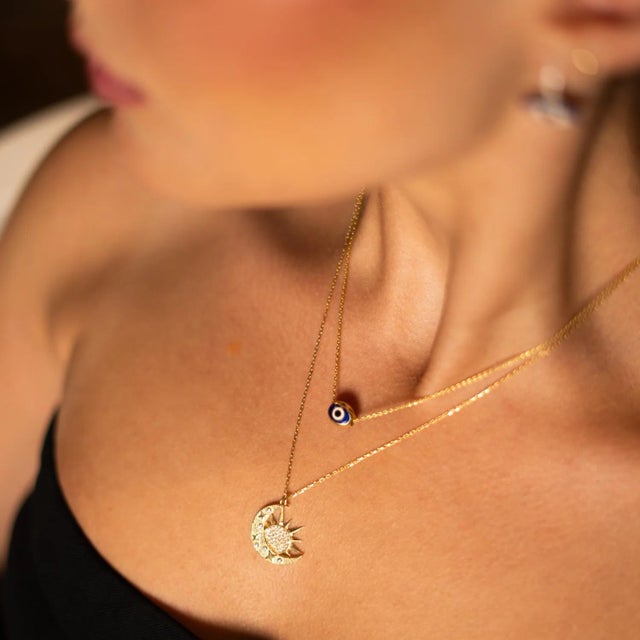 Bring timeless protection and modern elegance into your style with the Guardian Blue Evil Eye Minimalist Gold Necklace....