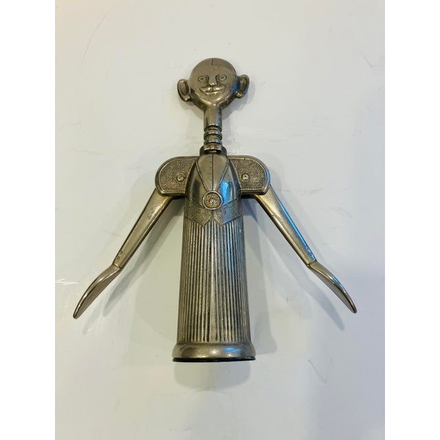 Designed by Aldo Columbo, Italy in the 80’s You raise the arms to remove the cork Pierre is silver plate wearing a bow tie...