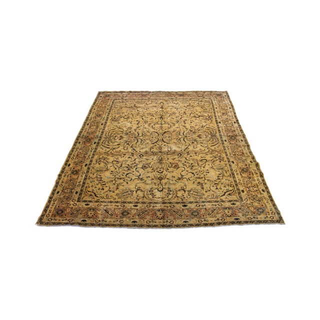 1920s Persian Tabriz wool rug, handcrafted, showcases a traditional floral pattern. The contrast between the golden...