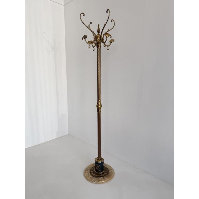 An elegant and highly decorative Italian brass hall tree produced during the 1960s. The design features a twisted brass...