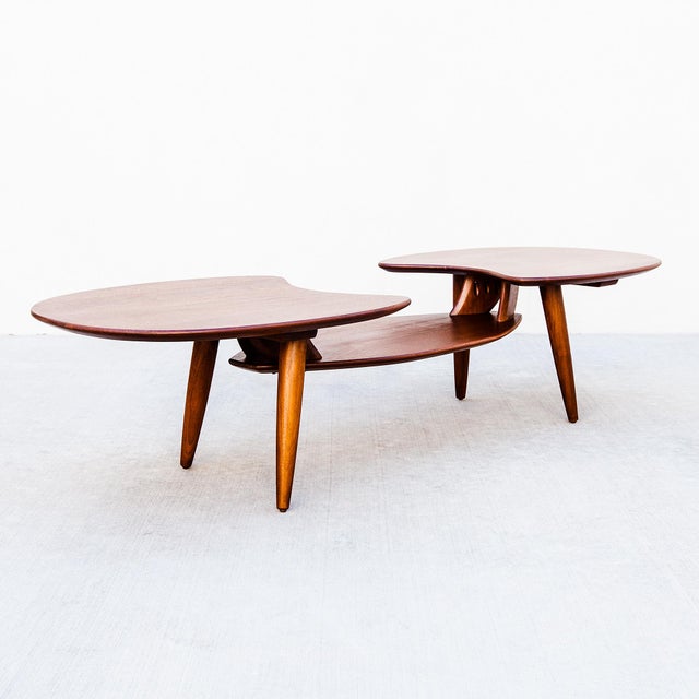 A newly refinished solid walnut biomorphic coffee or cocktail table with stiletto tapered legs, made in Southern...