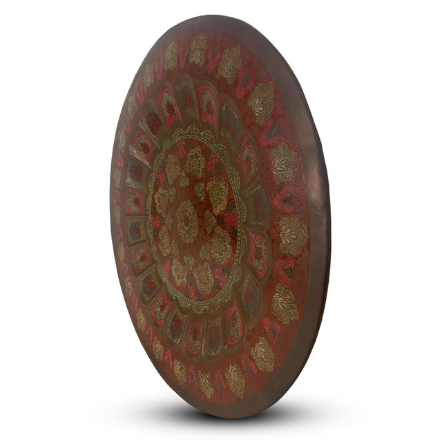 Striking large decorative wall charger crafted in embossed and engraved copper, featuring an elaborate Anglo-Indian...
