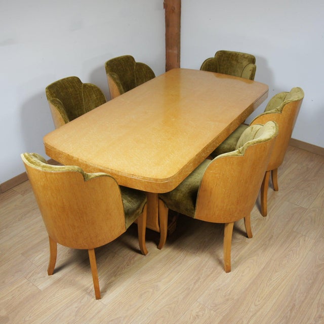 An art deco six seater 'cloud' dining suite by harry & lou epstein. Birdseye maple veneered throughout, set over a...