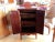 Small English serving unit in rosewood veneer opening with 2 doors. Brass handle. Feet straight. Its interior is lined...