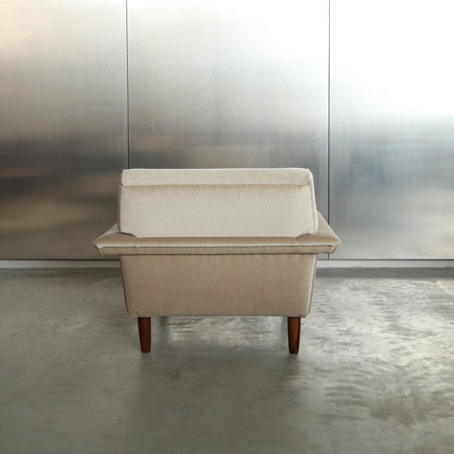 Elegant European lounge chair dating from the early 1960s. The chair features a strong architectural silhouette with broad...