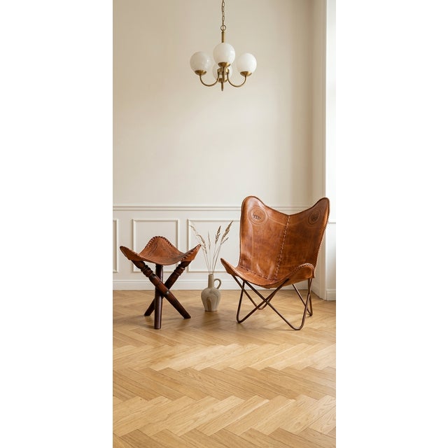 A rare and beautifully preserved artisan butterfly chair, showcasing exquisite South Asian craftsmanship. This statement...