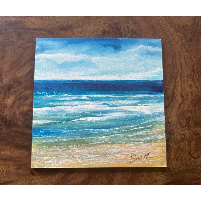 This vibrant watercolor captures the calming beauty of the ocean with rolling waves in shades of deep blue, turquoise, and...