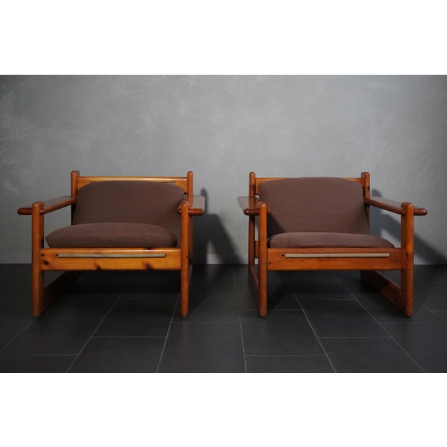 Pair of solid pine armchairs, made with a beautiful interlocking system of leather straps and wooden pins to anchor the...