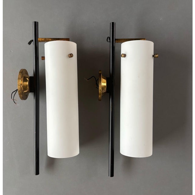 Beautiful pair of mid-century wall sconces, probably from the 1950s and in style of Stilnovo, known for its iconic Mid-...