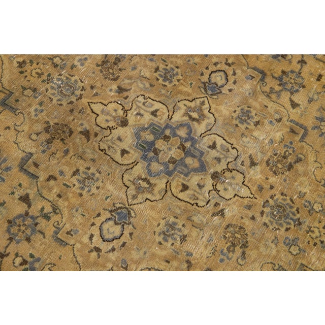 Beautiful antique Persian Tabriz hand-knotted wool rug with an ivory field. This piece has a beige frame and multicolor...