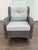 Design Plus Gallery presents an Outdoor Porch Glider Swivel Chair. The chair has a woven wicker-style frame with rolled...
