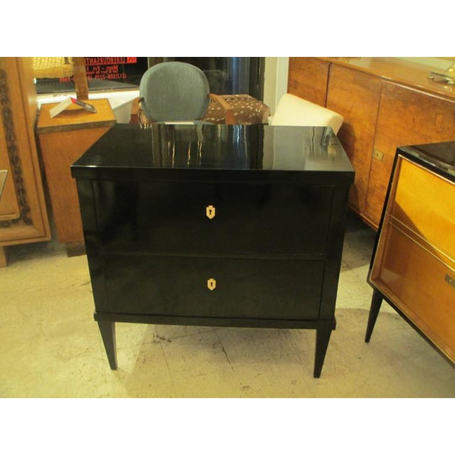 Ebonized Louis XVI style chest/commode on tapered legs with ebony escutcheons.