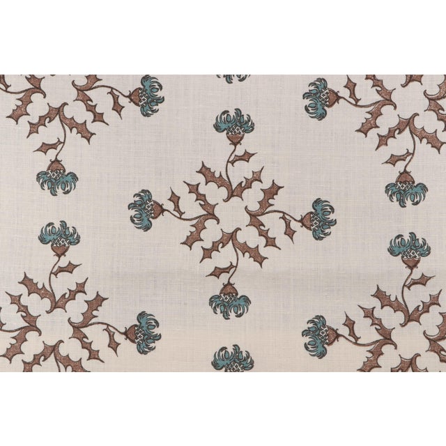 A geometric floral motif featuring a foliate diamond. Features tones of chestnut brown and mineral blue. Available piece...