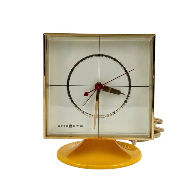 This vintage mid-century General Electric electric desk clock features a clean molded-plastic case raised on a sculptural...