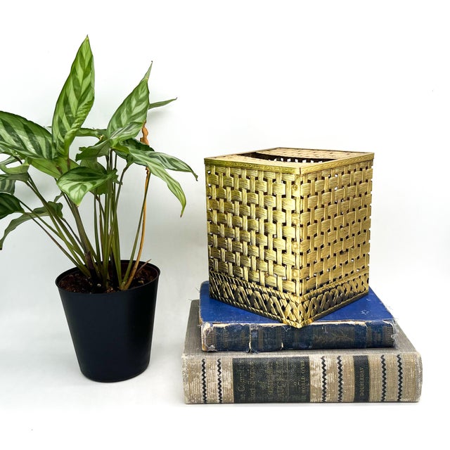 Glam, vintage gold-toned metal tissue box cover designed to resemble a finely woven basket. The openwork basketweave...