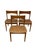 This set of three mid-century modern dining chairs features clean, understated lines and a warm wood finish typical of...
