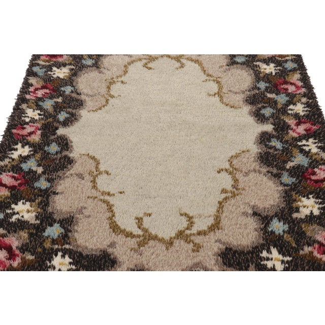 Hand-knotted in lush, high-pile wool in Sweden circa 1960-1970, this 4x7 vintage Swedish Rya rug is a bold new addition to...