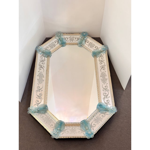 Luxury mirror in Murano glass with transparent-gold and light-blue flowers full of gold leaf inside. Venetian hand-carved...