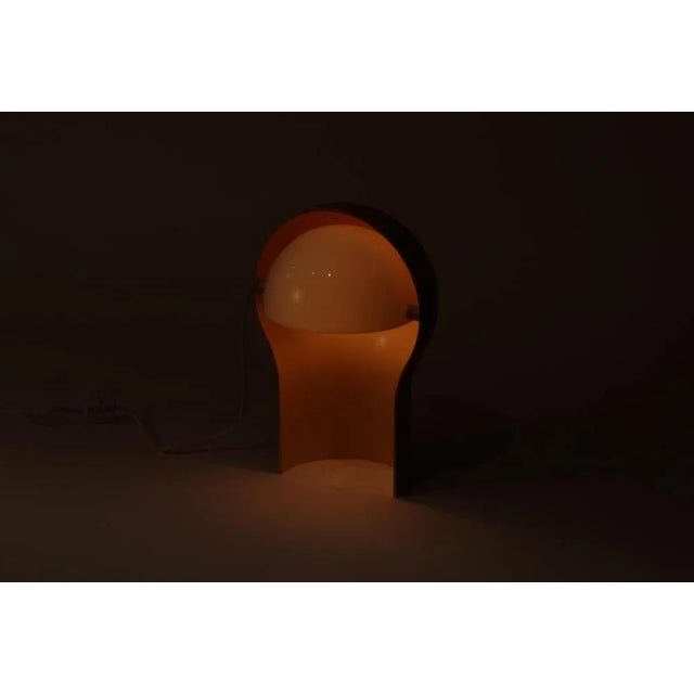 Original Telegono table lamp designed in 1968 by Vico Magistretti for Artemide, Italy. The pale white hemispherical inner...