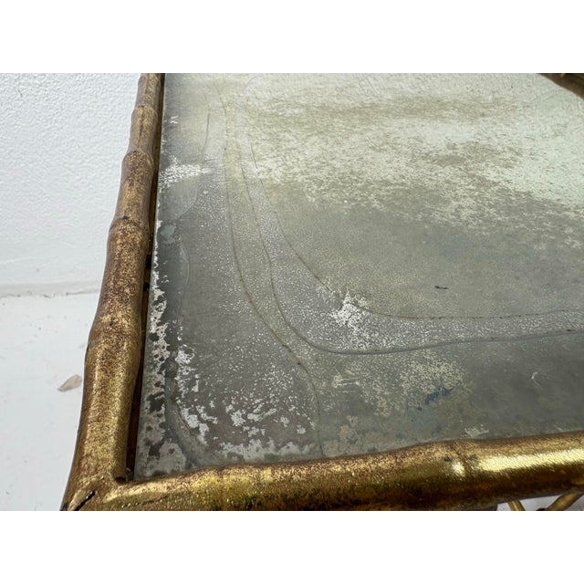This is a vintage set of Gilded metal nesting tables. These nesting tables have a faux bamboo design to the metal with...