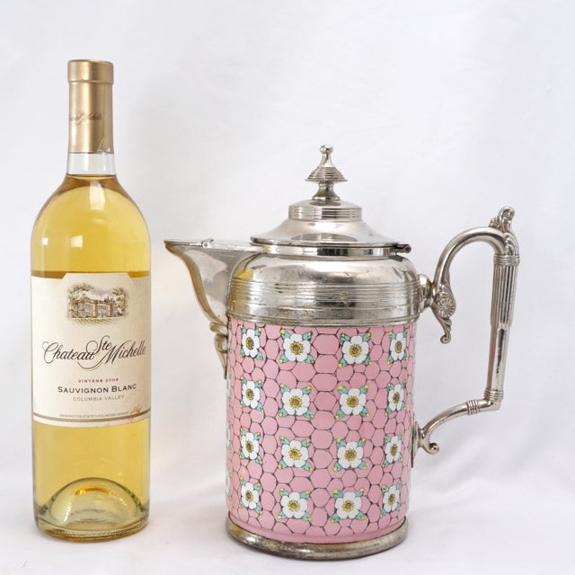A striking Victorian-era coffee pot that features a vibrant, heavy base metal body expertly enameled inside and out. The...
