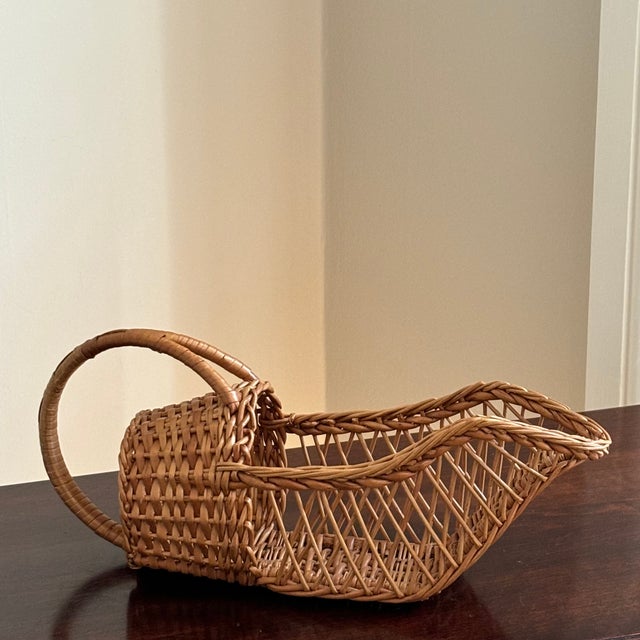A wonderfully preserved 1960s Boho wicker wine bottle holder. Use at the dinner table or display in a kitchen or home bar....