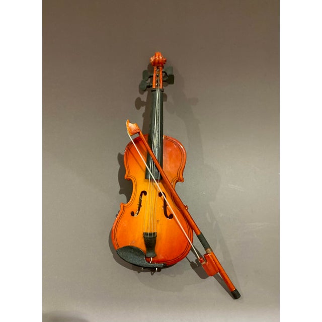 This unique miniature wooden violin and bow with a latched carrying case will make the perfect gift for the violinist or...