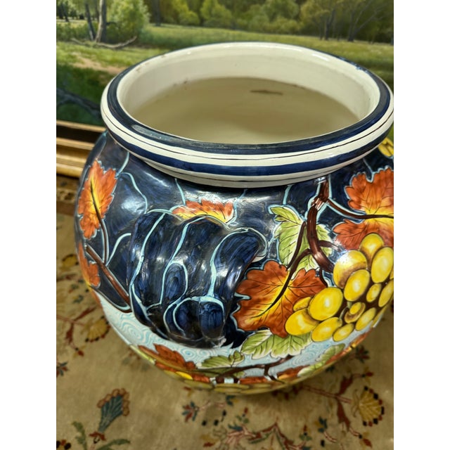 Design Plus Gallery presents a Contemporary Italian Majolica Urn. The ceramic vase has vibrant, hand-painted fruit with...