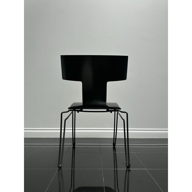 A refined postmodern design by John Hutton for Donghia, the Anziano chair pairs a sculptural curved back with a slender...