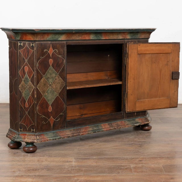 This narrow console has an Italianesque feel, due to the stylized paint which is old but not original to this pine...