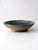 This handcrafted vintage bowl has a wide, shallow form and substantial weight, perfect as a serving piece or decorative...
