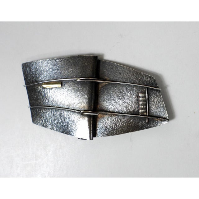 Late 20th century artist studio made abstract silver brooch. Texture silver folded with wire and small bits of gold...