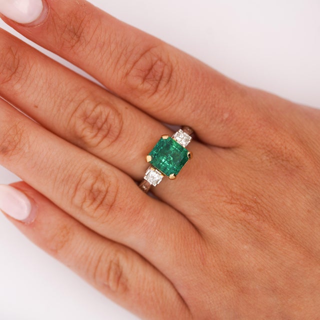 GIA certified 3.38 carat Colombian emerald ring in platinum featuring 0.70 carat princess cut diamonds with intricate...