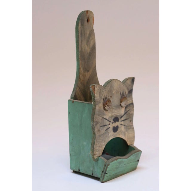 Hand-carved Folk Art matchbook holder with attached metal eyes and original hand-painted details (ca. 1940s, USA). Primary...