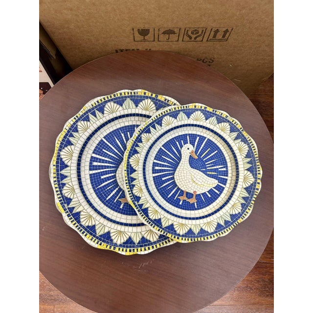 A set of two Baroque-style ceramic plates featuring vintage-inspired scalloped edges. The design incorporates a visual...