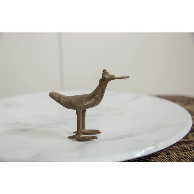 :: Vintage handmade African bronze flat billed bird. Circa mid 20th century and possibly older, this piece has such...