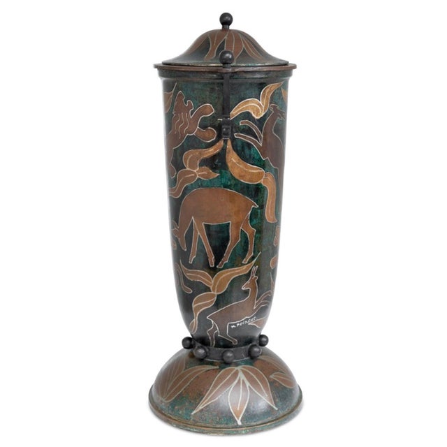 French Patinated Copper Two Handle Covered Vase, early 20th century, decorated overall with lions and antelopes among...