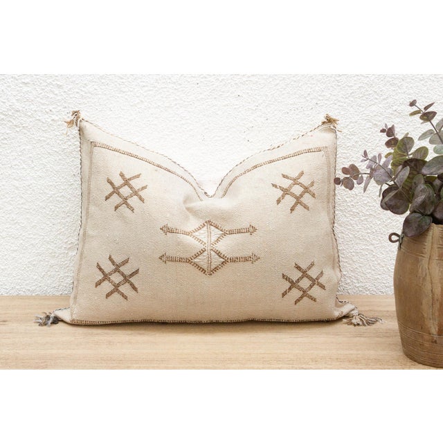 Introduce a touch of earthy elegance with our handcrafted lumbar/rectangular Moroccan cactus silk pillow. Woven from the...