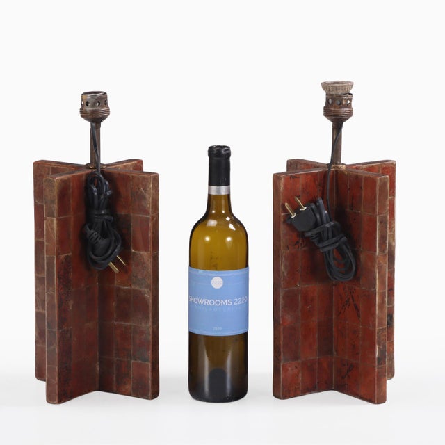 A pair of striking lamp bases of cruciform form, entirely clad in a meticulously arranged patchwork of natural mica...