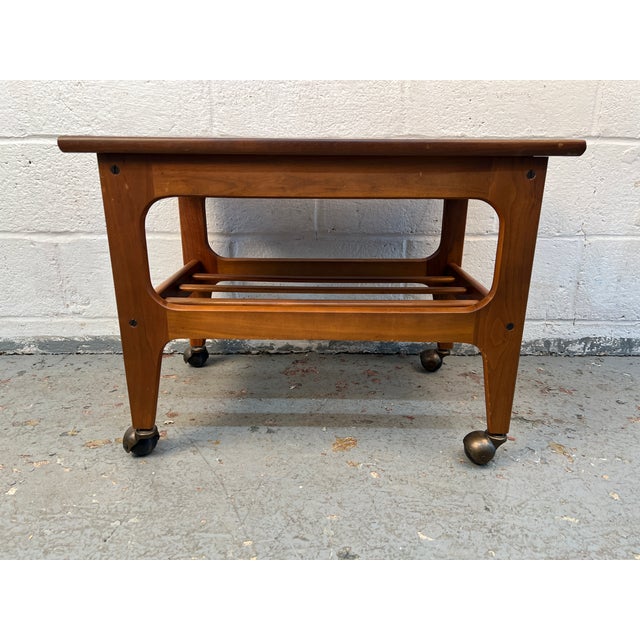 Stylish mid-century modern teak trolley featuring clean Scandinavian-inspired lines and a practical, versatile design. The...