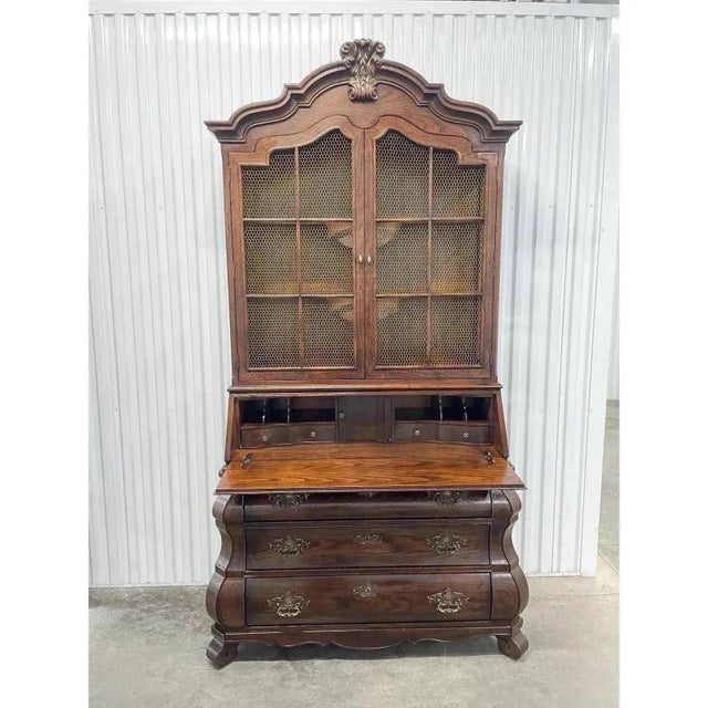 French Country bombe style slant front secretary desk by Henredon, from their Four Centuries collection. Solid oak, brass...