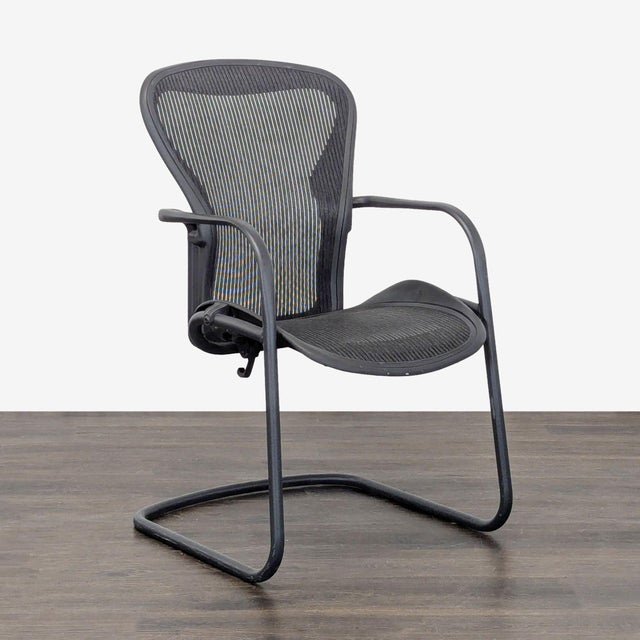 This Herman Miller chair features a sleek black mesh seat and back for breathability and comfort. Its cantilever base...